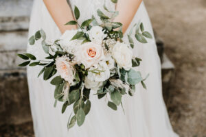 close up of bride holding bunch of flowers vintage style